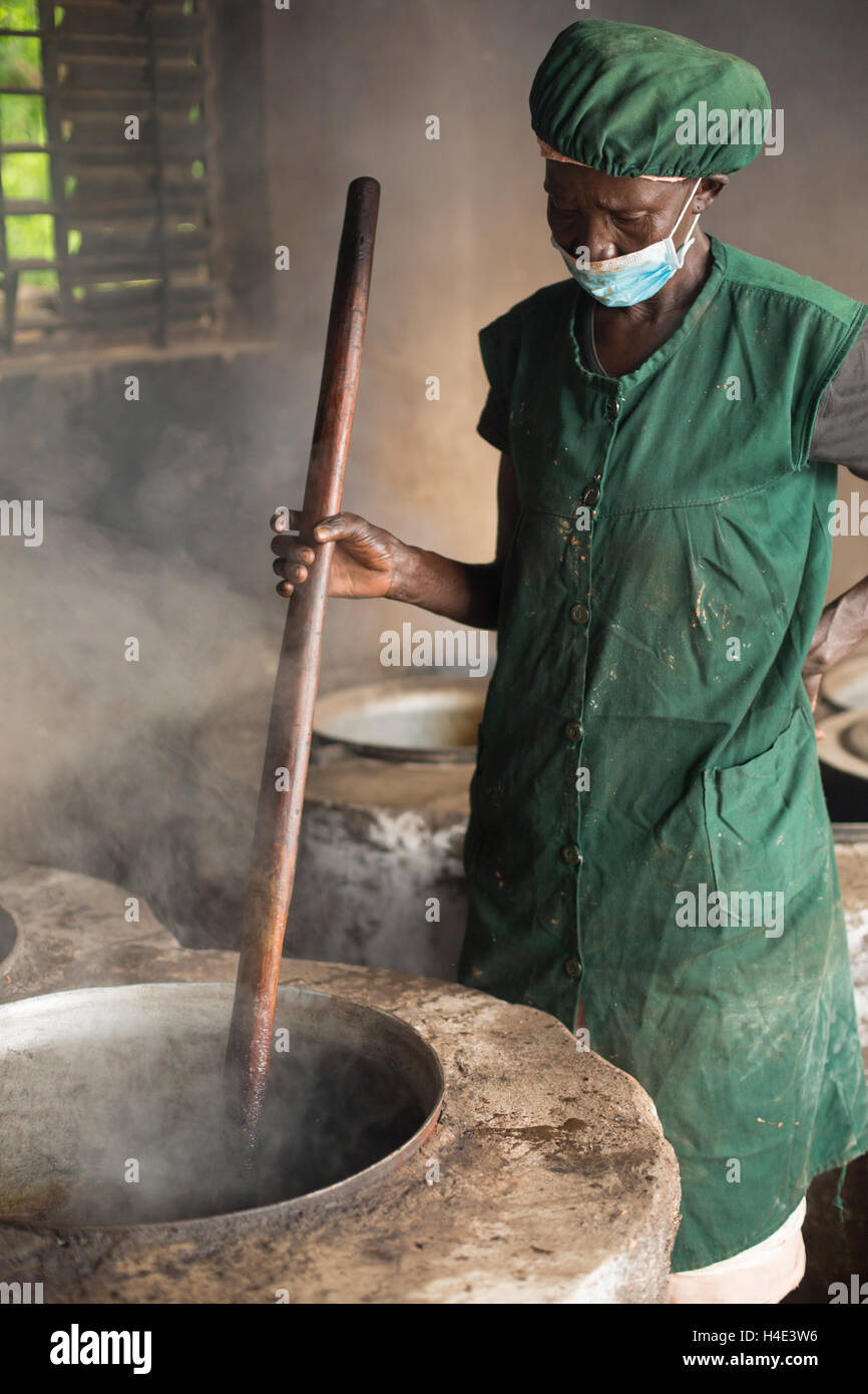 Les processus d'un employé dans l'huile de beurre de karité du commerce équitable à un site de production à réo, Burkina Faso, Afrique de l'Ouest. Banque D'Images