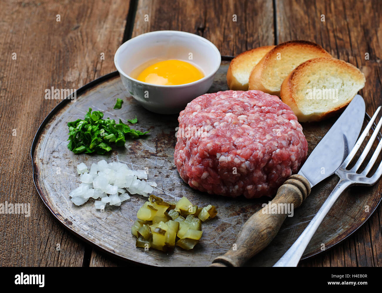 Tartare de boeuf frais avec l'oeuf, cornichon et l'oignon. Selective focus Banque D'Images