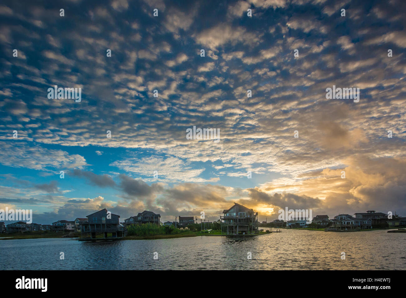 Soleil se lève de l'nuages sur Avon Caroline du Nord sur l'île Hatteras de bancs extérieurs OBX reflétant dans Pamlico Sound Banque D'Images
