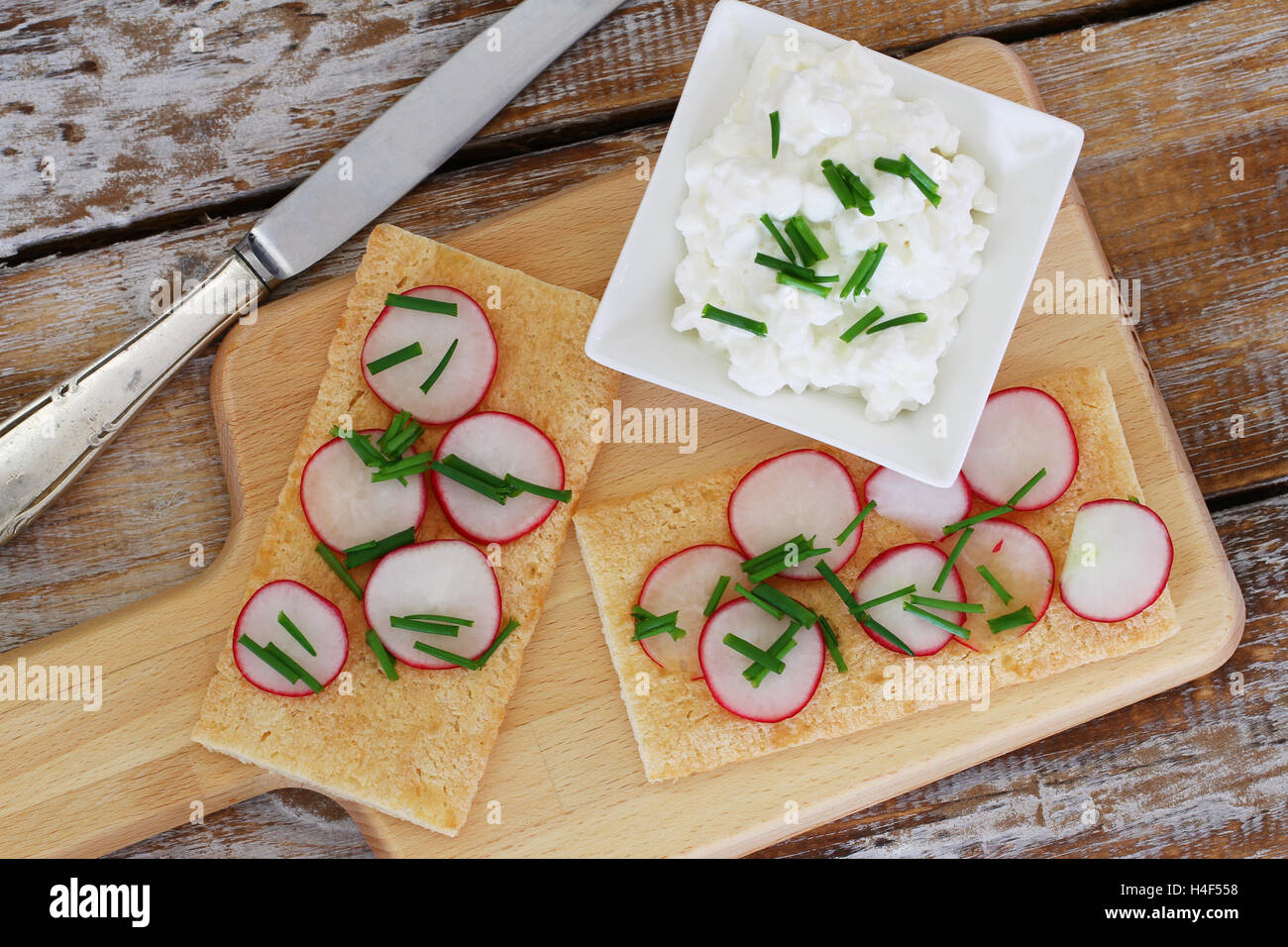 Petit-déjeuner composé de pain frais croustillant avec radis et bol de fromage cottage Banque D'Images