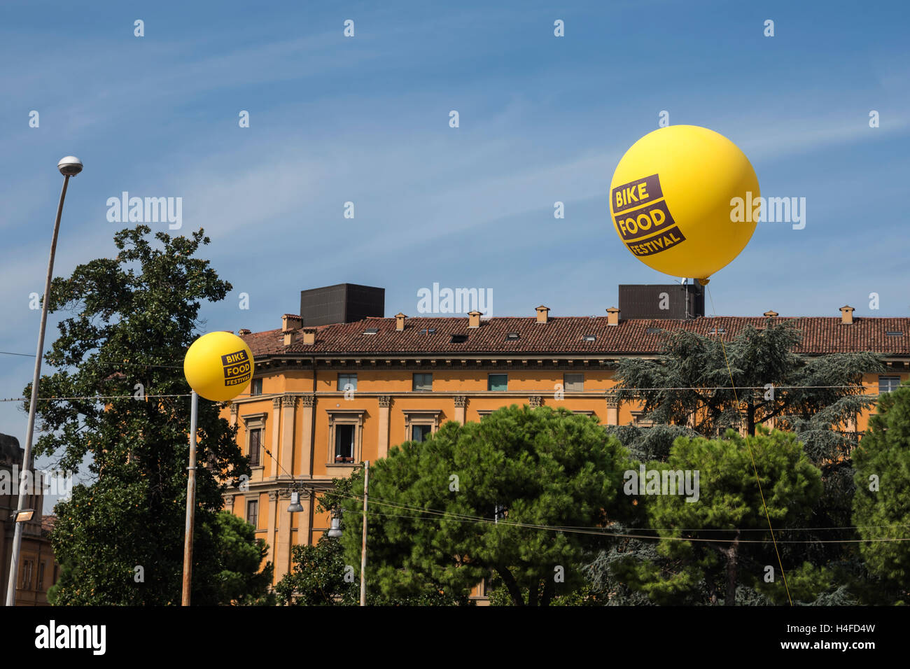 Énormes ballons jaunes lumineux au-dessus des toits de la ville, Bologne, Italie, Europe Banque D'Images