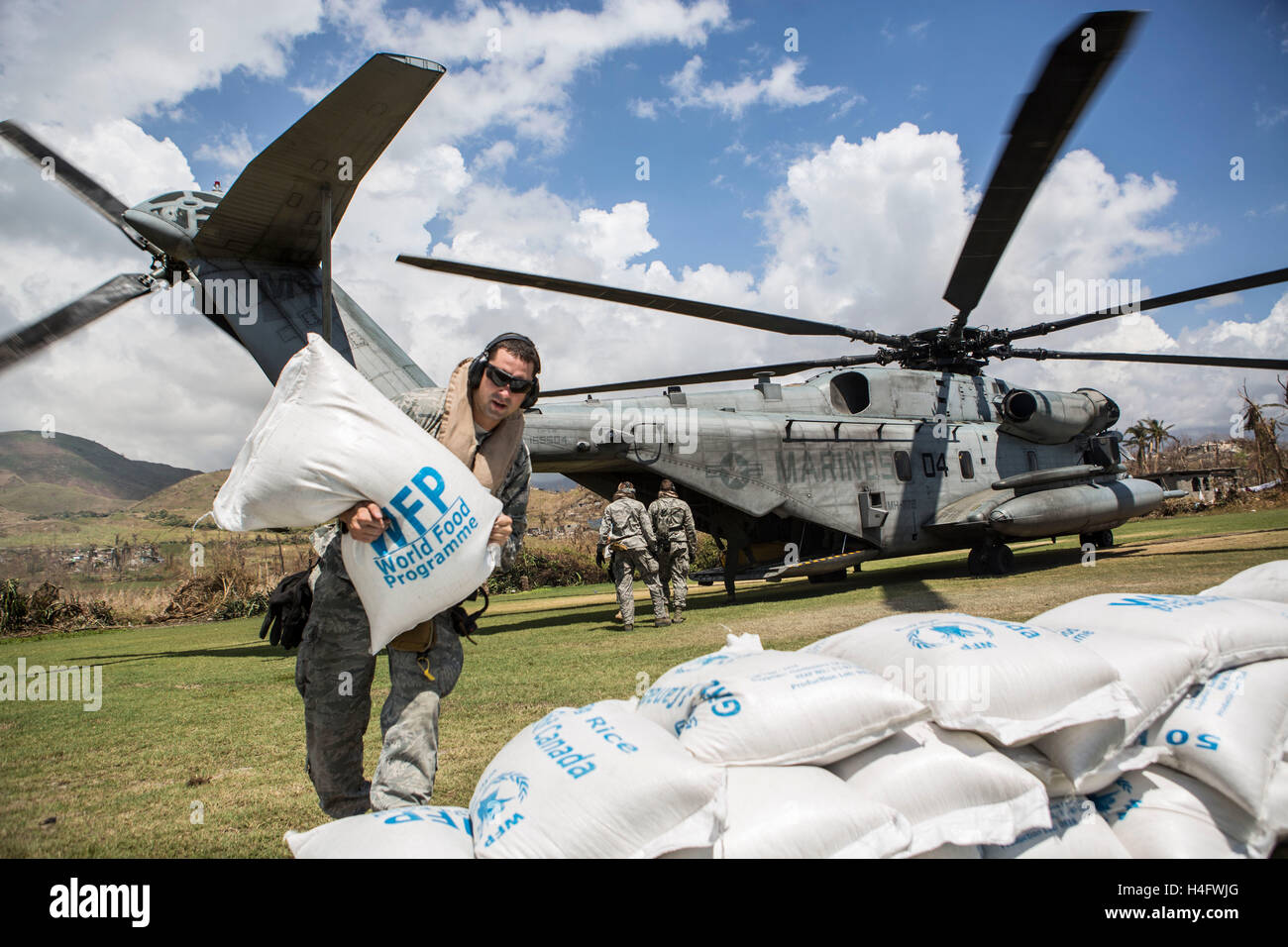 Les membres du Service américain de décharger des sacs de riz d'un CH-53E Super Stallion helicopter pour participer aux efforts de reconstruction après le passage de l'Ouragan Matthew 13 octobre 2016 dans les Anglais, en Haïti. L'ouragan Matthew a frappé Haïti, tuant au moins 500 personnes et causant des dommages catastrophiques à des parties de l'île. Banque D'Images