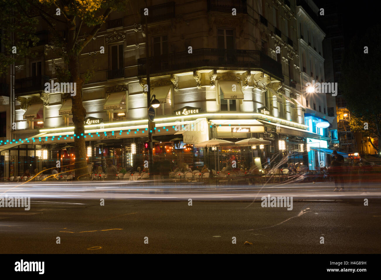 PARIS, FRANCE - 13ème Août 2016 : une vue dans une rue de Paris la nuit montrant le mouvement flou de personnes et de restaurants, cafés et autres commerces Banque D'Images