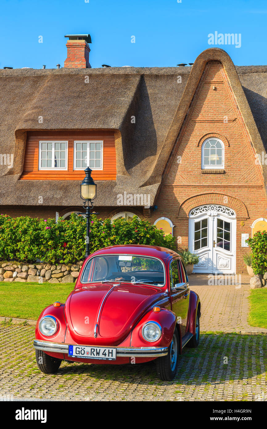 L'île de Sylt, ALLEMAGNE - SEP 6, 2016 : Volkswagen Beetle classique garé en face de la maison typique frison avec toit de chaume à Kam Banque D'Images