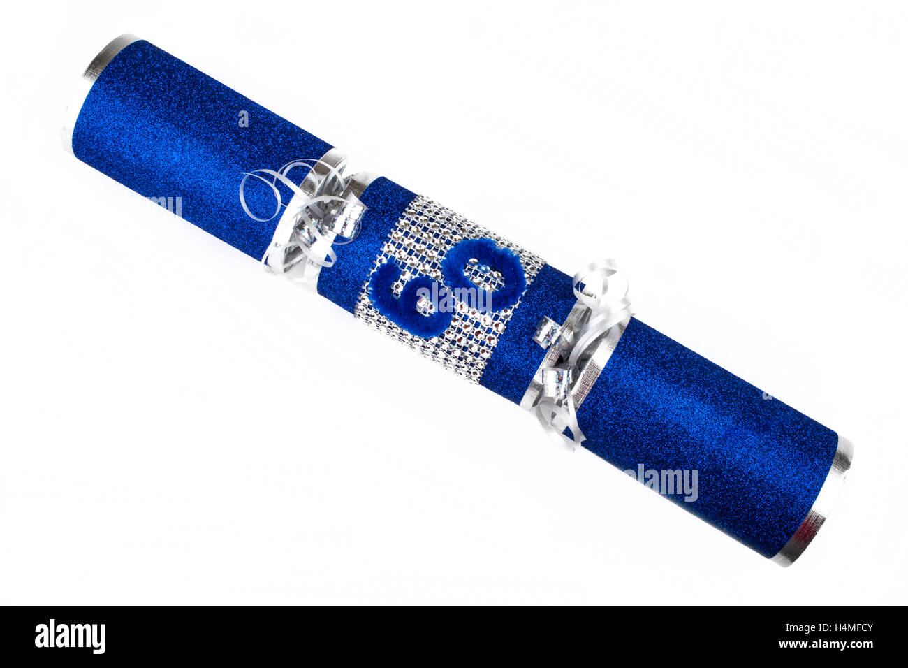 La prise d'un 60e anniversaire ou anniversaire Cracker aussi connu comme un bon bon. Un pirate se compose d'un tube de carton enveloppé dans un b Banque D'Images