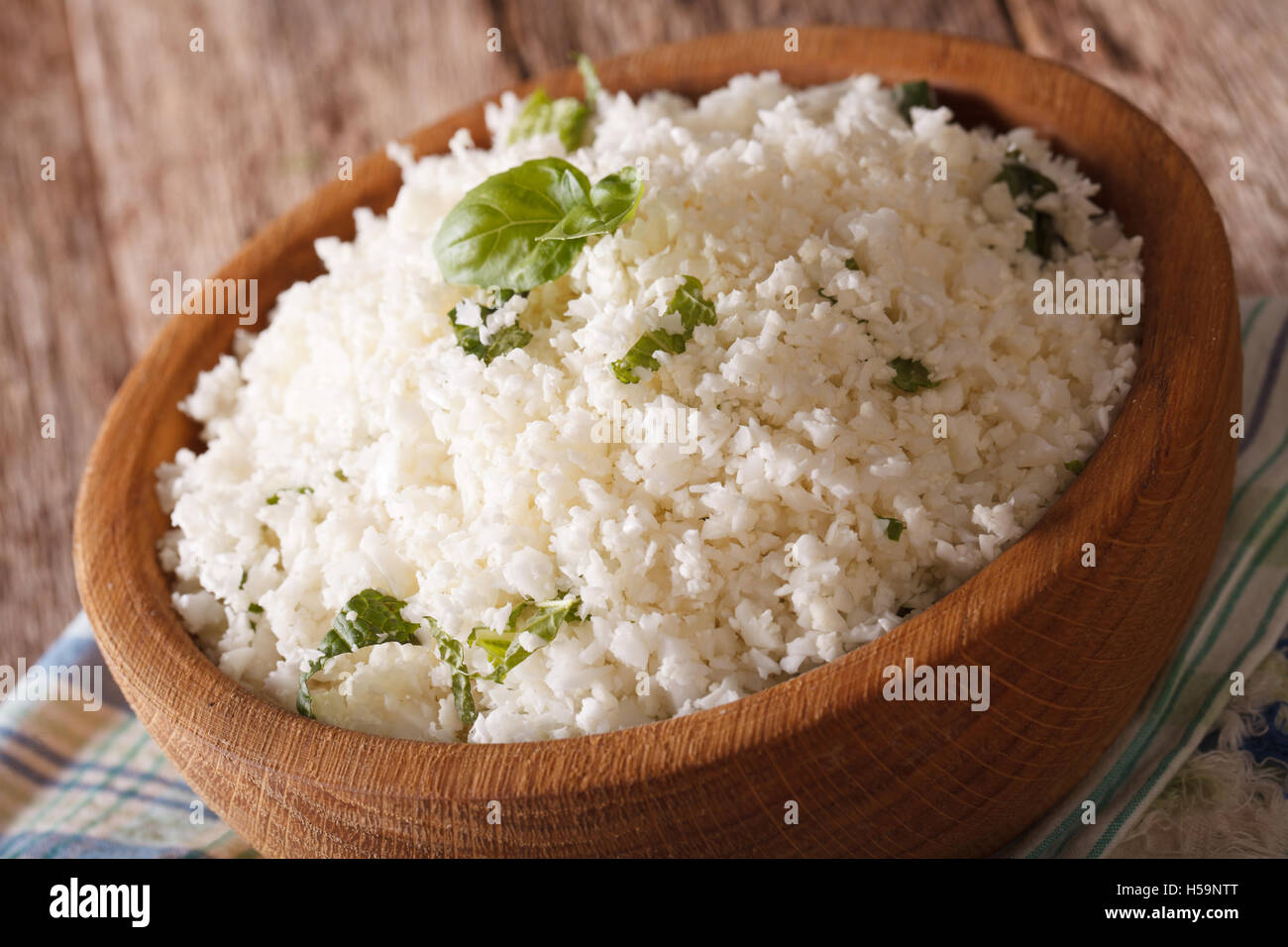 Le chou-fleur au basilic riz close up dans un bol sur la table horizontale. Banque D'Images