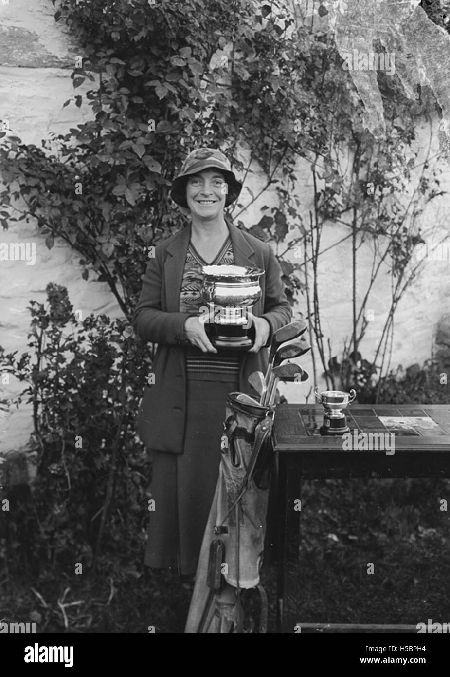 Photographie d'une dame tenant une coupe au Builth Wells Golf Club, marquant probablement une victoire ou une occasion spéciale au club. Banque D'Images