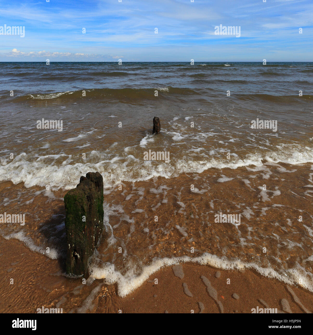 Clapotis des vagues à terre à Brancaster, Norfolk, Angleterre, Royaume-Uni. Banque D'Images