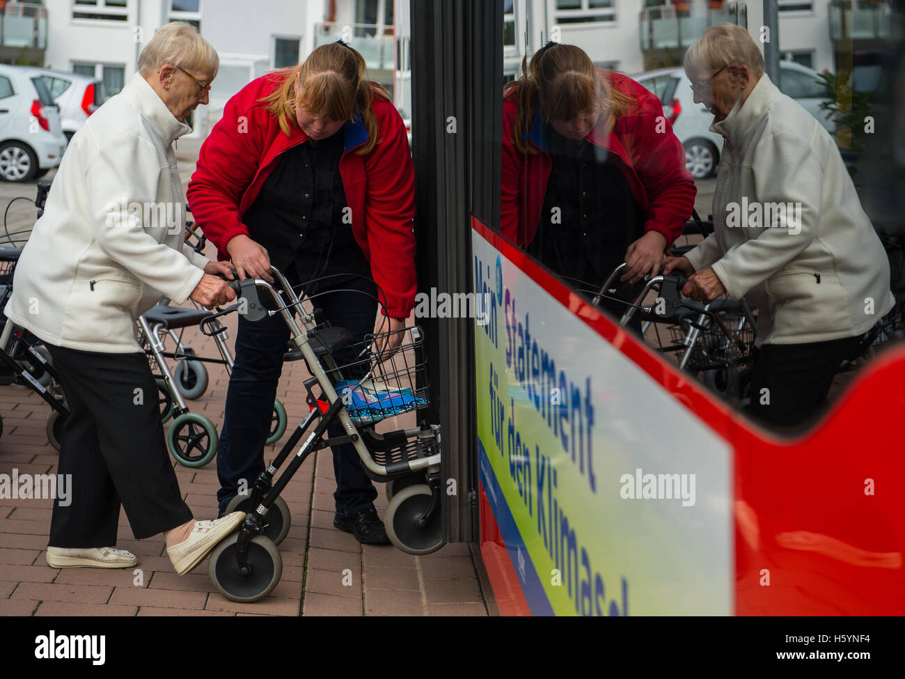 Tröstau, Allemagne. 18 Oct, 2016. Coach Nancy Ferber (r) enseigne Henny Druck (91) la façon la plus sécuritaire d'entrer dans le bus avec son déambulateur à la maison de soins infirmiers 'Haus Jacobus' à Osthofen, Allemagne, 18 octobre 2016. La société 'DB' Suedwest Bus Regio propose une formation à la mobilité pour la sécurité le bus pour les personnes âgées, les cadres supérieurs de l'École appelé bus. PHOTO : ANDREAS ARNOLD/dpa/Alamy Live News Banque D'Images