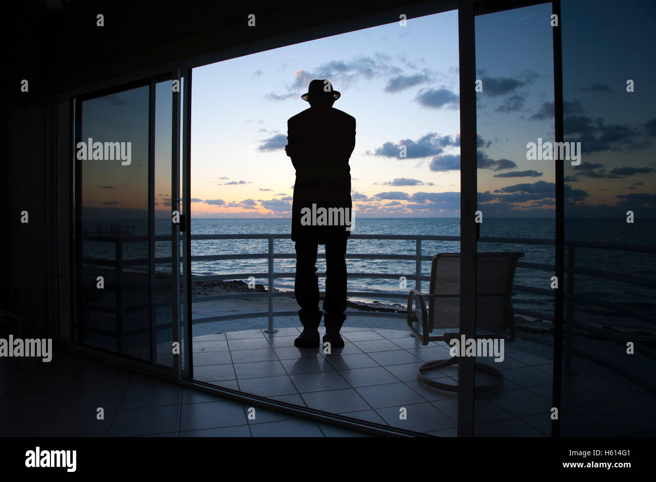 Vue arrière Silhouette of Man sur balcon face à la mer Banque D'Images