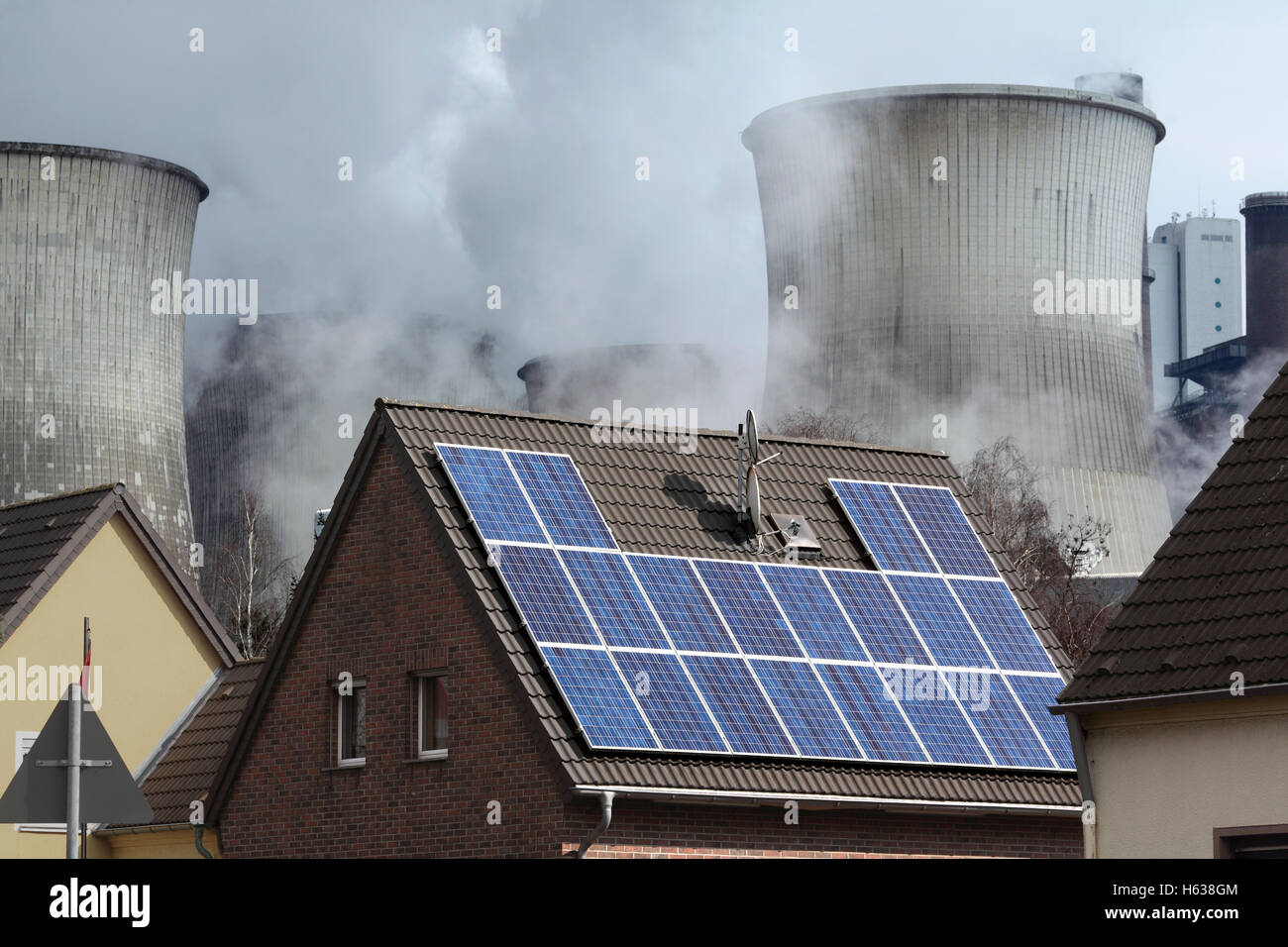 Des sources d'énergie : une énergie solaire (PV) produisant du système sur un toit de maison à côté d'une centrale électrique au charbon, Allemagne Banque D'Images