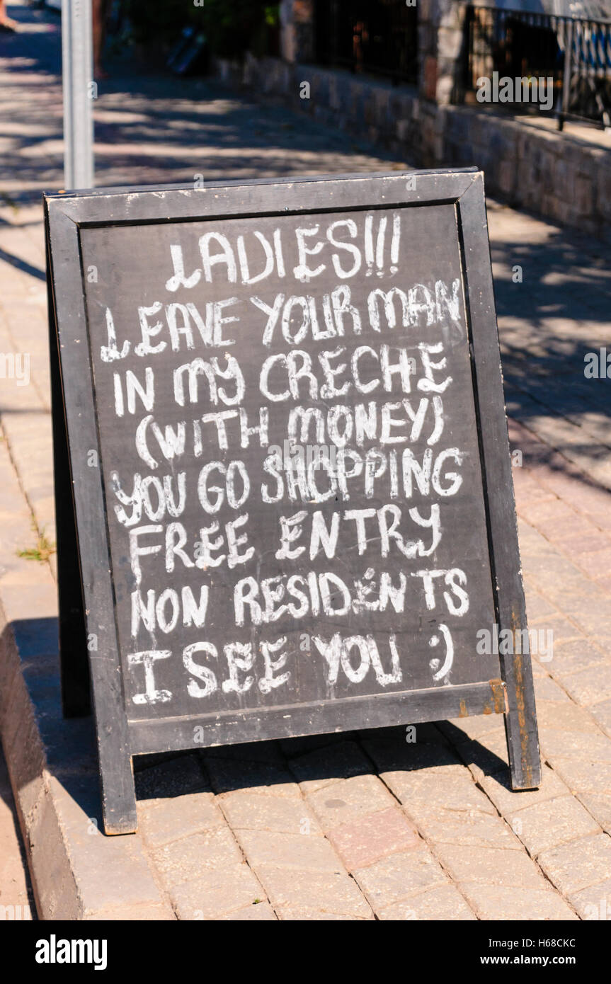 Tableau noir à l'extérieur d'un bar de l'hôtel turc conseiller mesdames de laisser votre homme dans ma crèche (bar) à faire du shopping. Banque D'Images