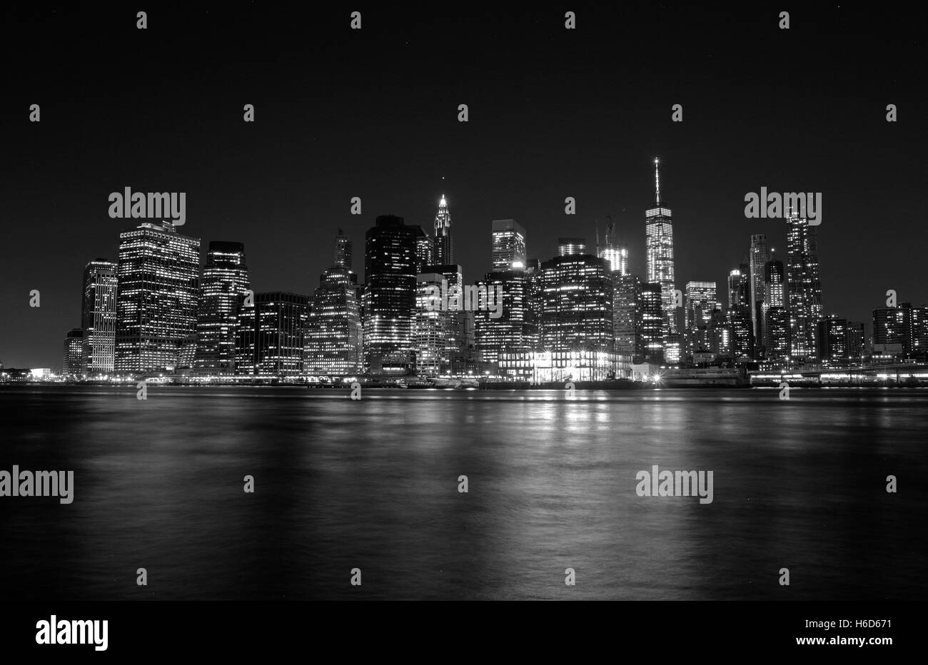 Une vue de nuit de Manhattan à travers l'East River de Brooklyn, NY, États-Unis. En B&W. Banque D'Images