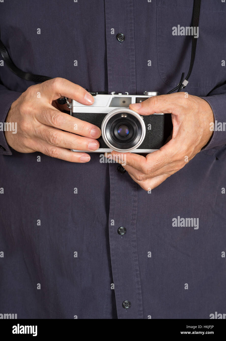 Les mains tenant un appareil photo compact analog Banque D'Images