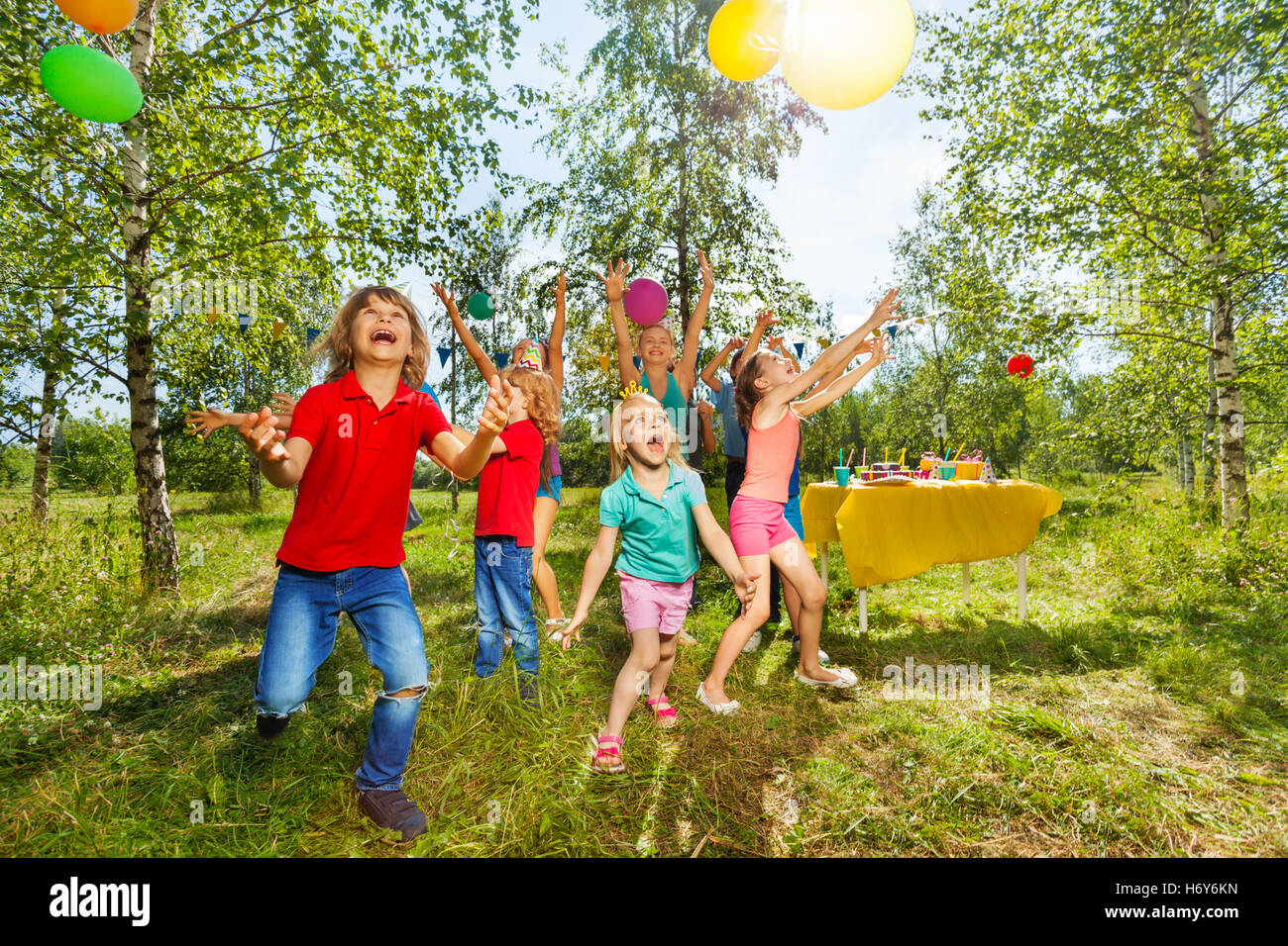 Heureux les enfants jouant au ballon parc d'été Banque D'Images