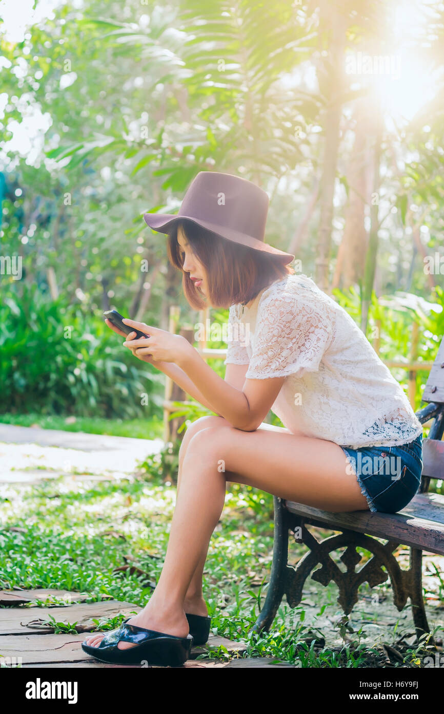 Girl with smartphone in park Banque D'Images