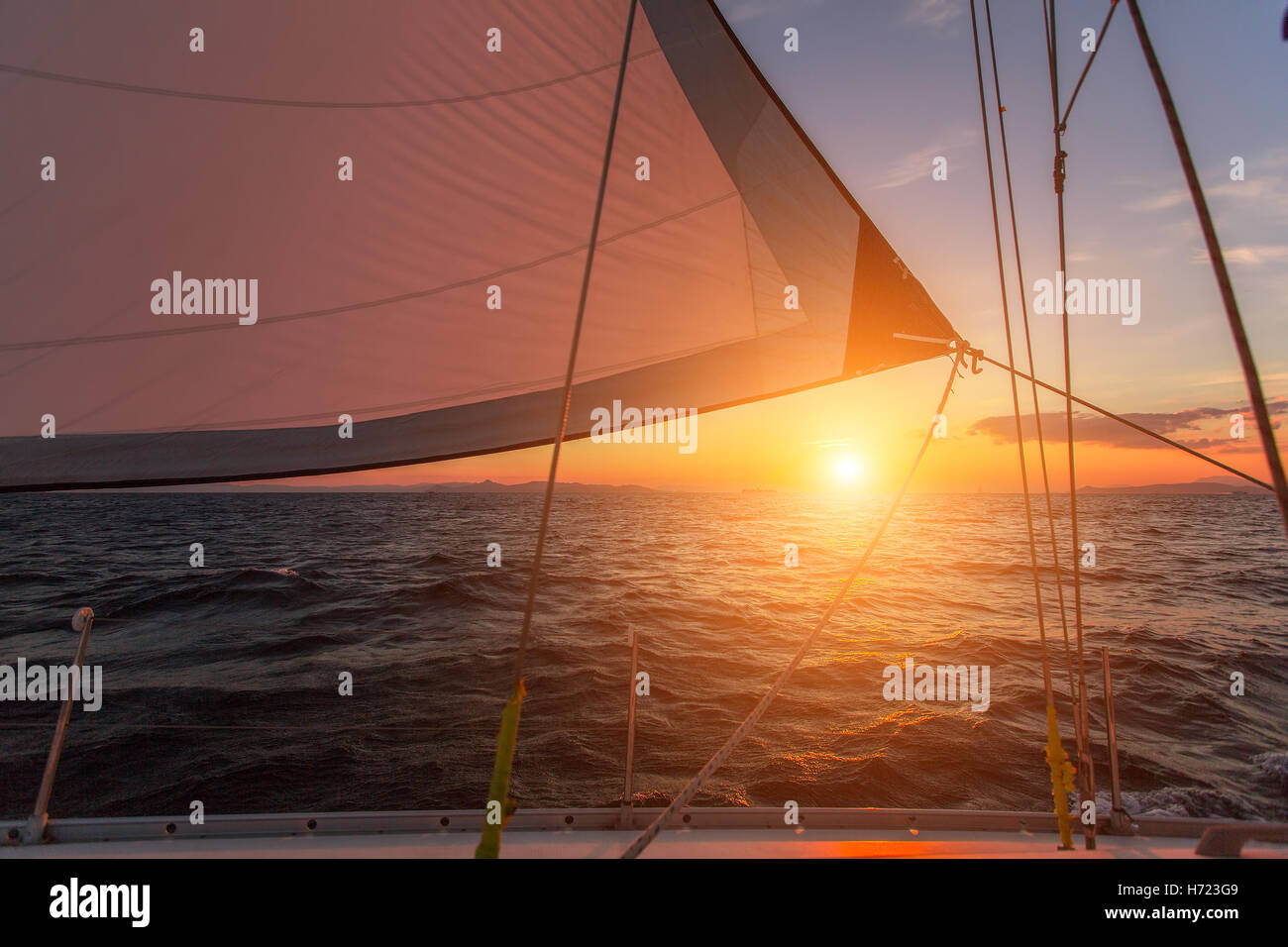 Magnifique coucher de soleil en mer d'une balle dans le gréement d'un yacht à voile. Banque D'Images