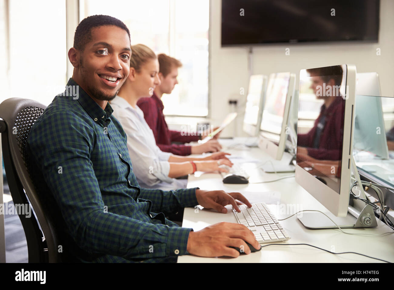 Portrait Of Male University Student en utilisant des ressources en ligne Banque D'Images
