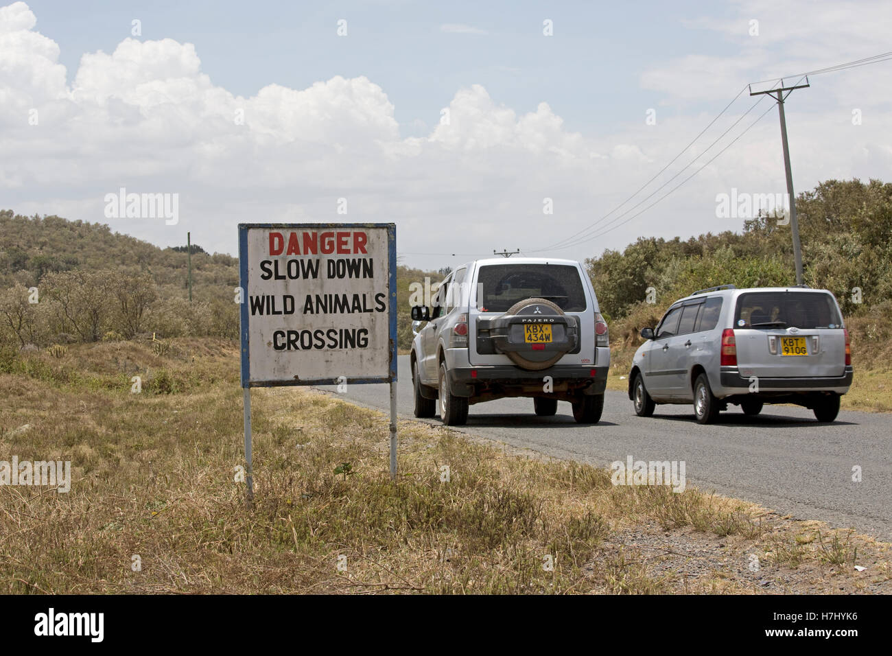Panneau d'avertissement ralentir le passage des animaux sauvages avec des voitures sur la route Hells Gate Naivasha au Kenya Banque D'Images