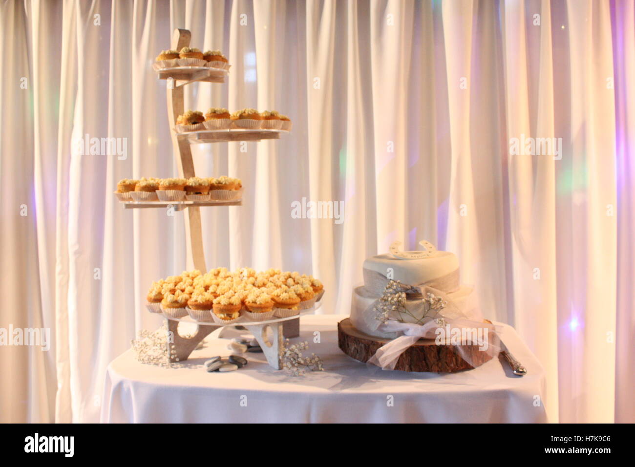 Gâteau de mariage avec fleurs et ruban log stand - stand de cupcakes Banque D'Images