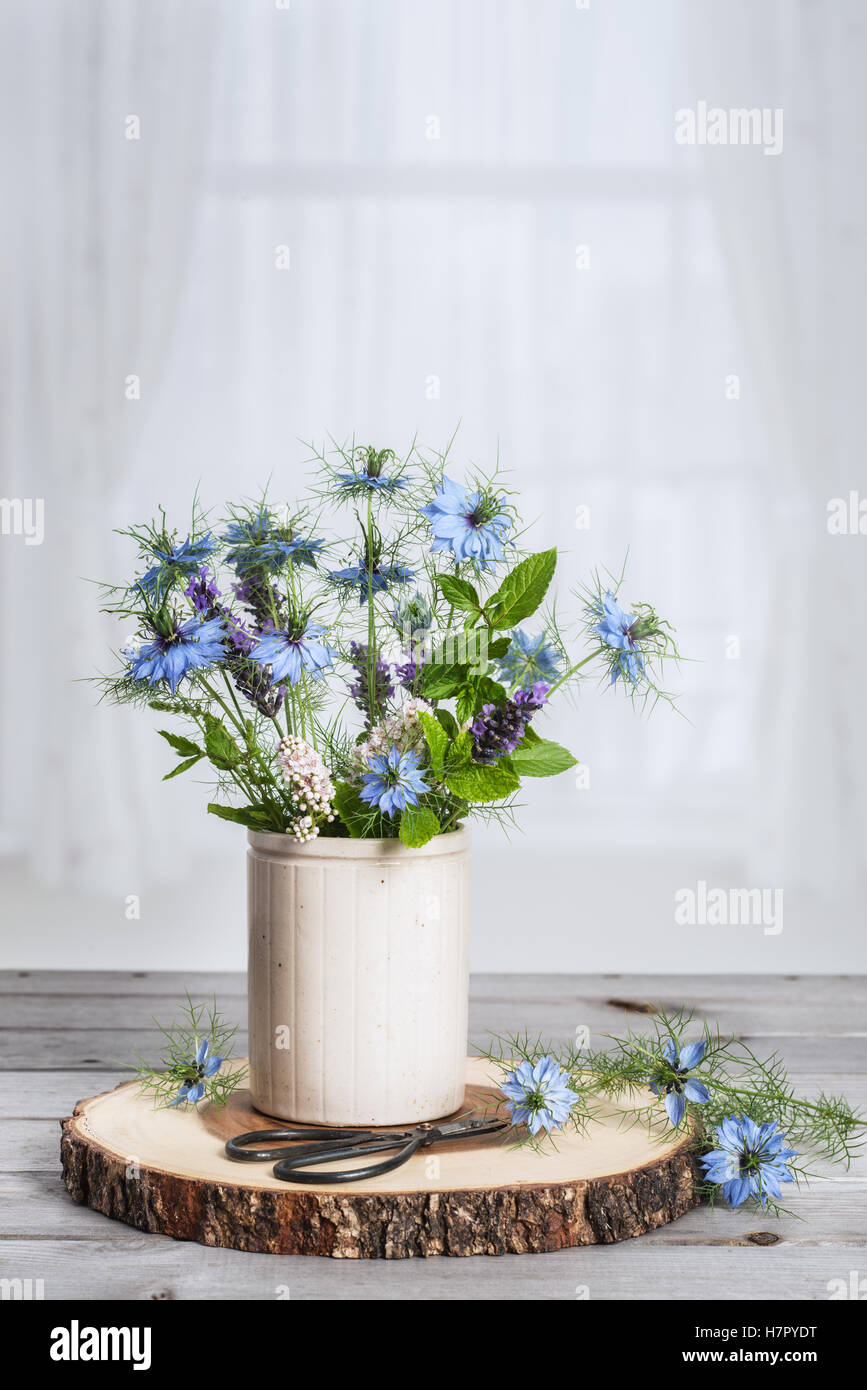 Pot en céramique de fleurs sauvages assis dans la fenêtre Banque D'Images