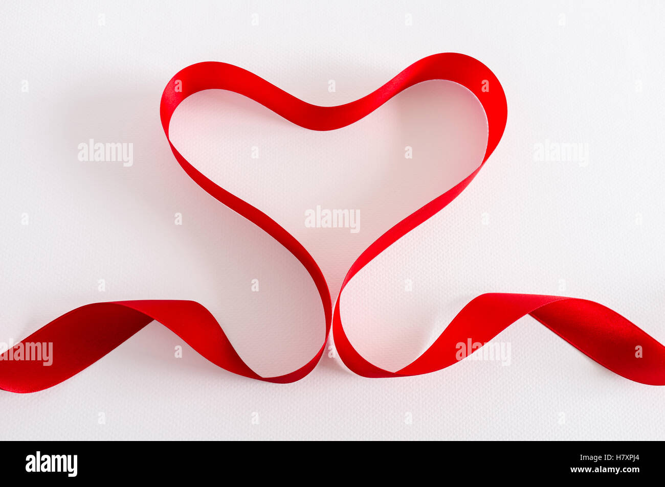 Valentine. Ruban de satin rouge. Isolé sur blanc. La conception de la frontière. Banque D'Images