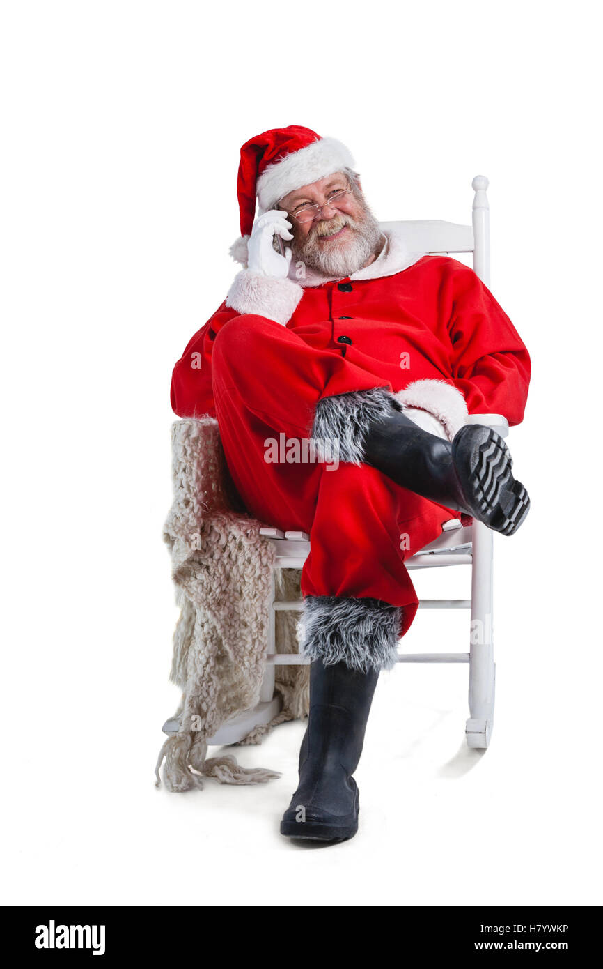 Santa Claus talking on mobile phone Banque D'Images