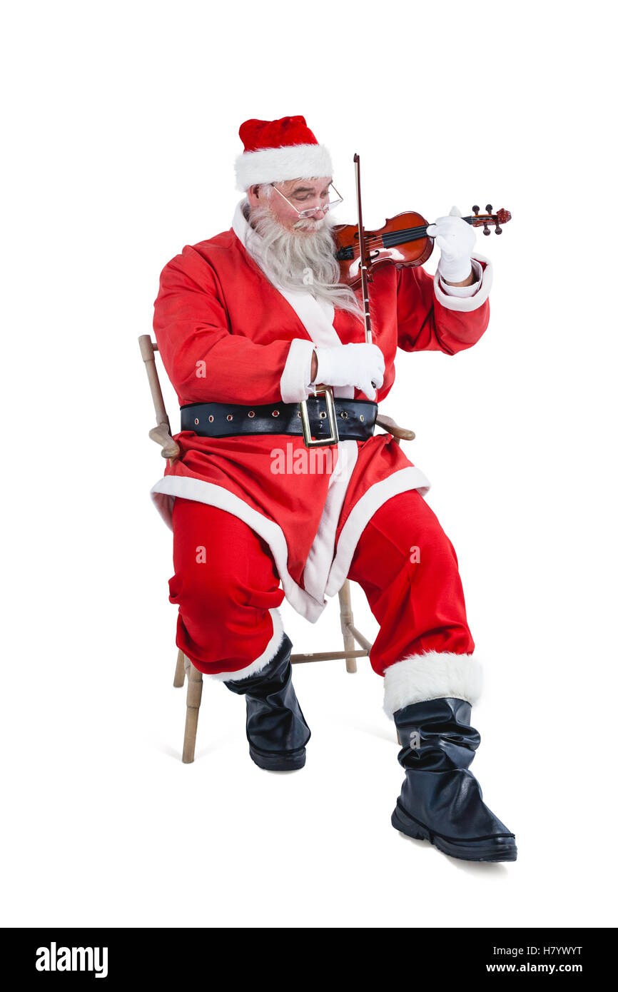 Smiling santa claus playing violin Banque D'Images