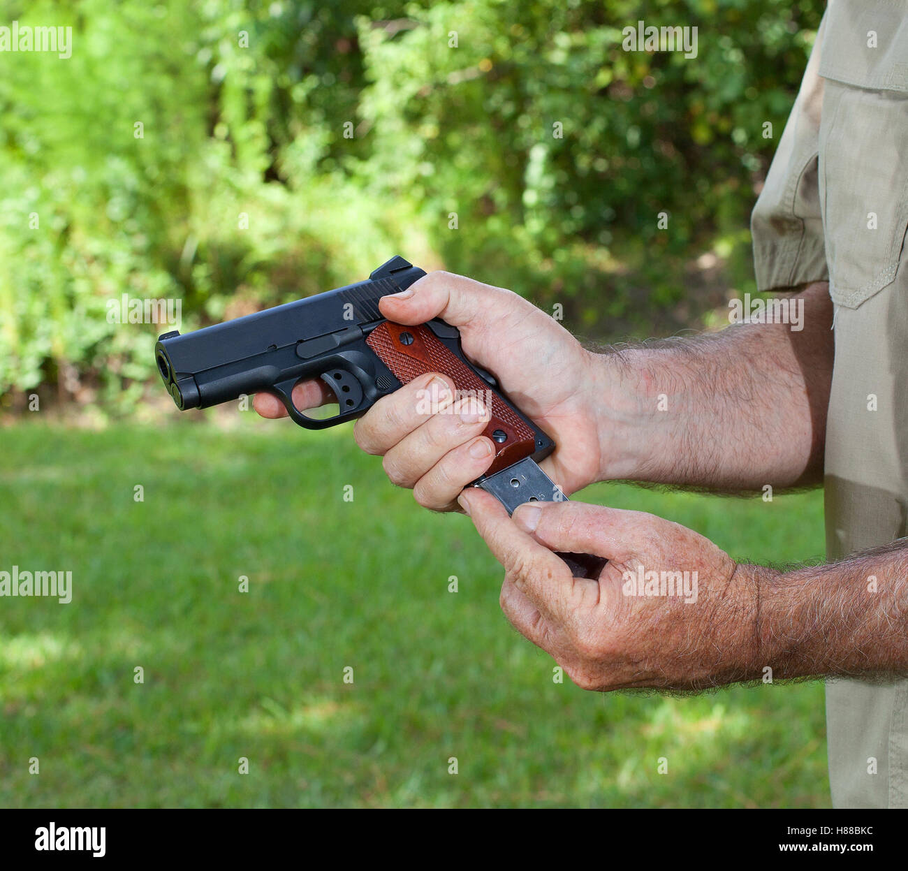Magazine de couleur argent d'être insérées dans un pistolet Banque D'Images