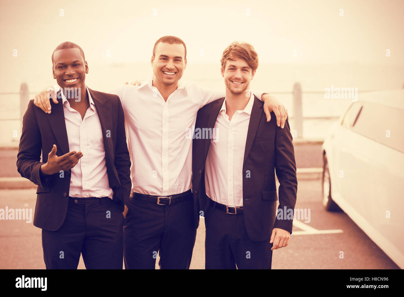 Portrait de beaux hommes posant à côté de limousine Banque D'Images