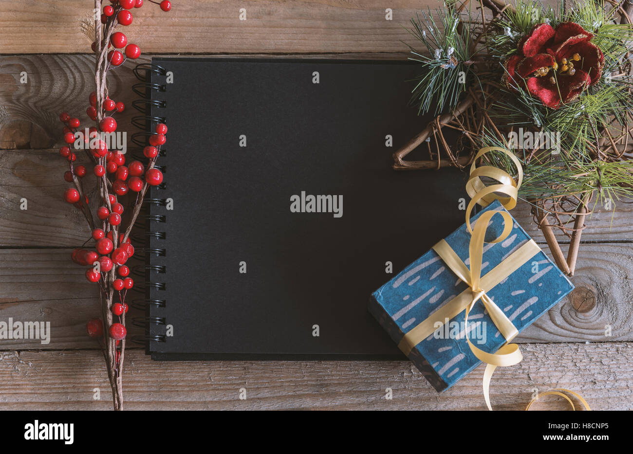 Image de la maquette sur le thème de Noël avec l'ordinateur portable ou d'un album photo vide sur fond de bois. Banque D'Images