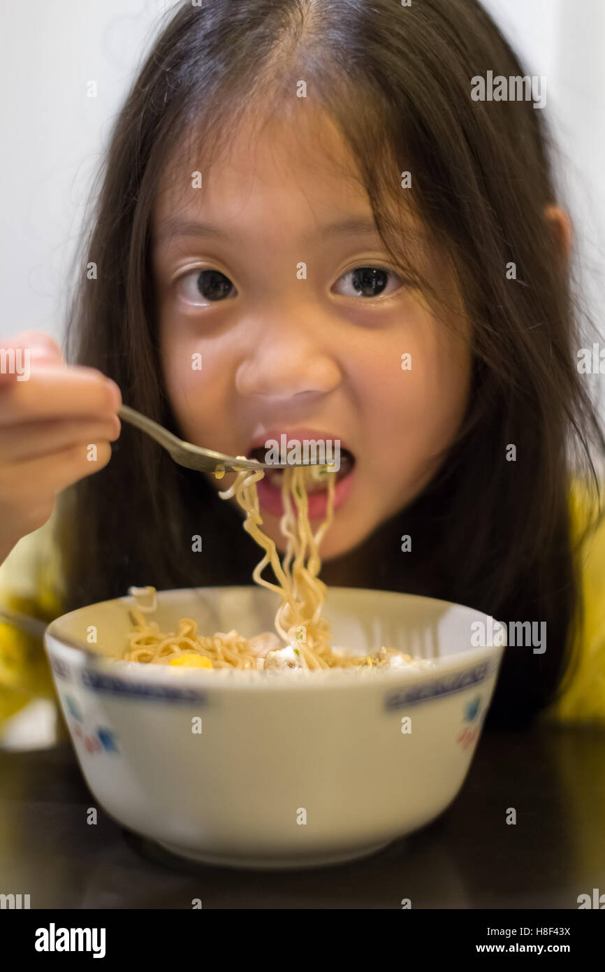 Enfant qui a faim de manger ou de nouilles ramen chinois. Banque D'Images