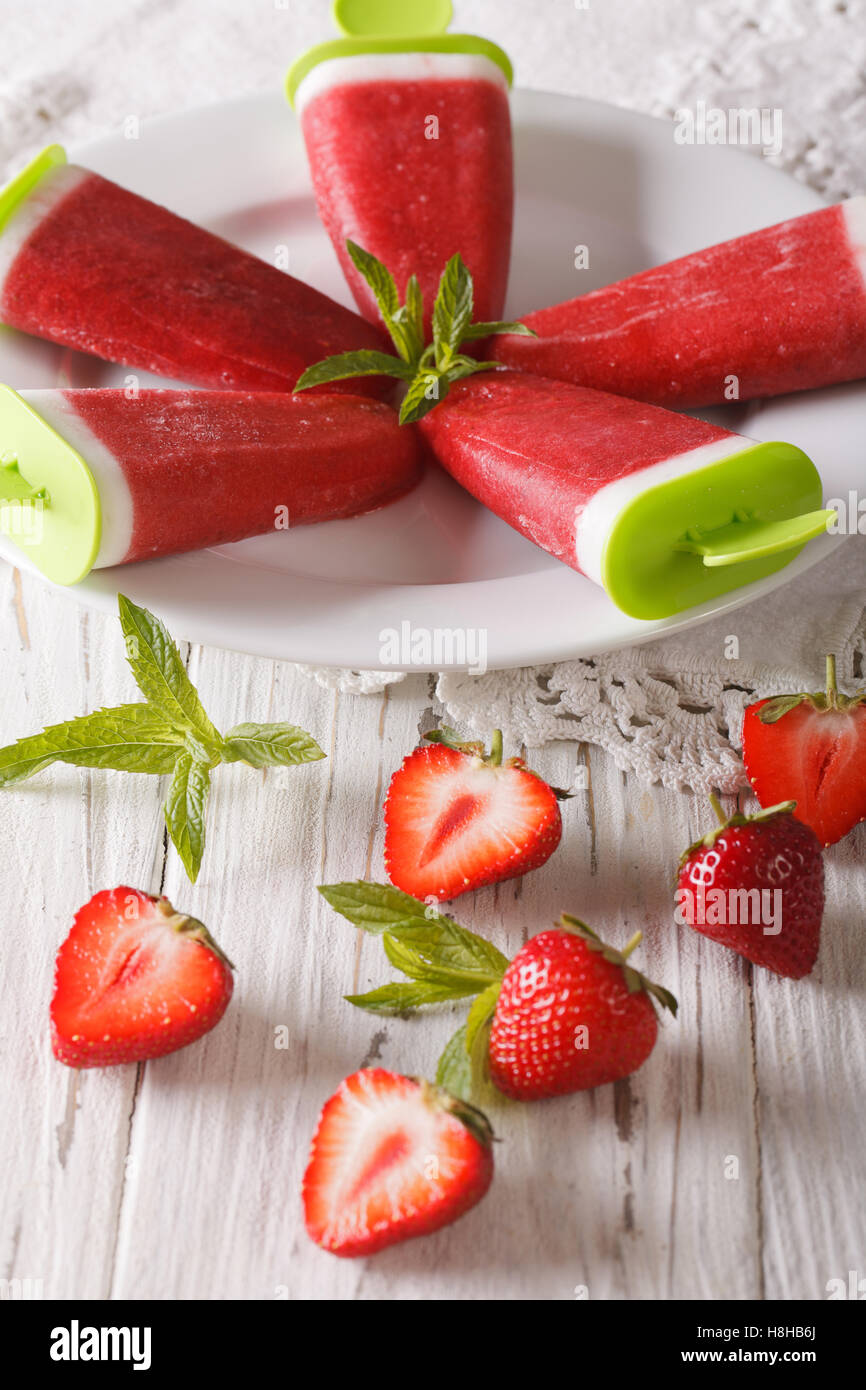 Glace à la fraise à la menthe sur un bâton libre sur une plaque verticale. Banque D'Images