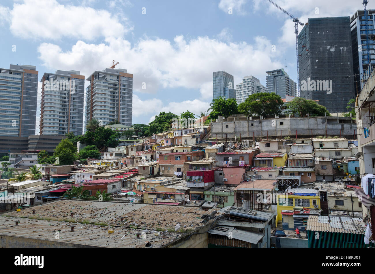 Maisons colorées des pauvres habitants de Luanda, en Angola. Ces ghettos contrastent vivement avec la riche moderne des gratte-ciel en arrière-plan Banque D'Images