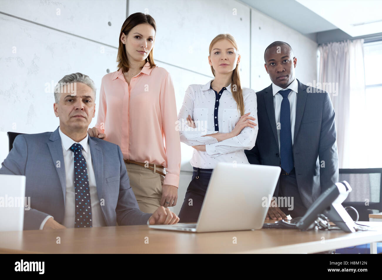 Portrait of multi-ethnic business people at desk in office Banque D'Images