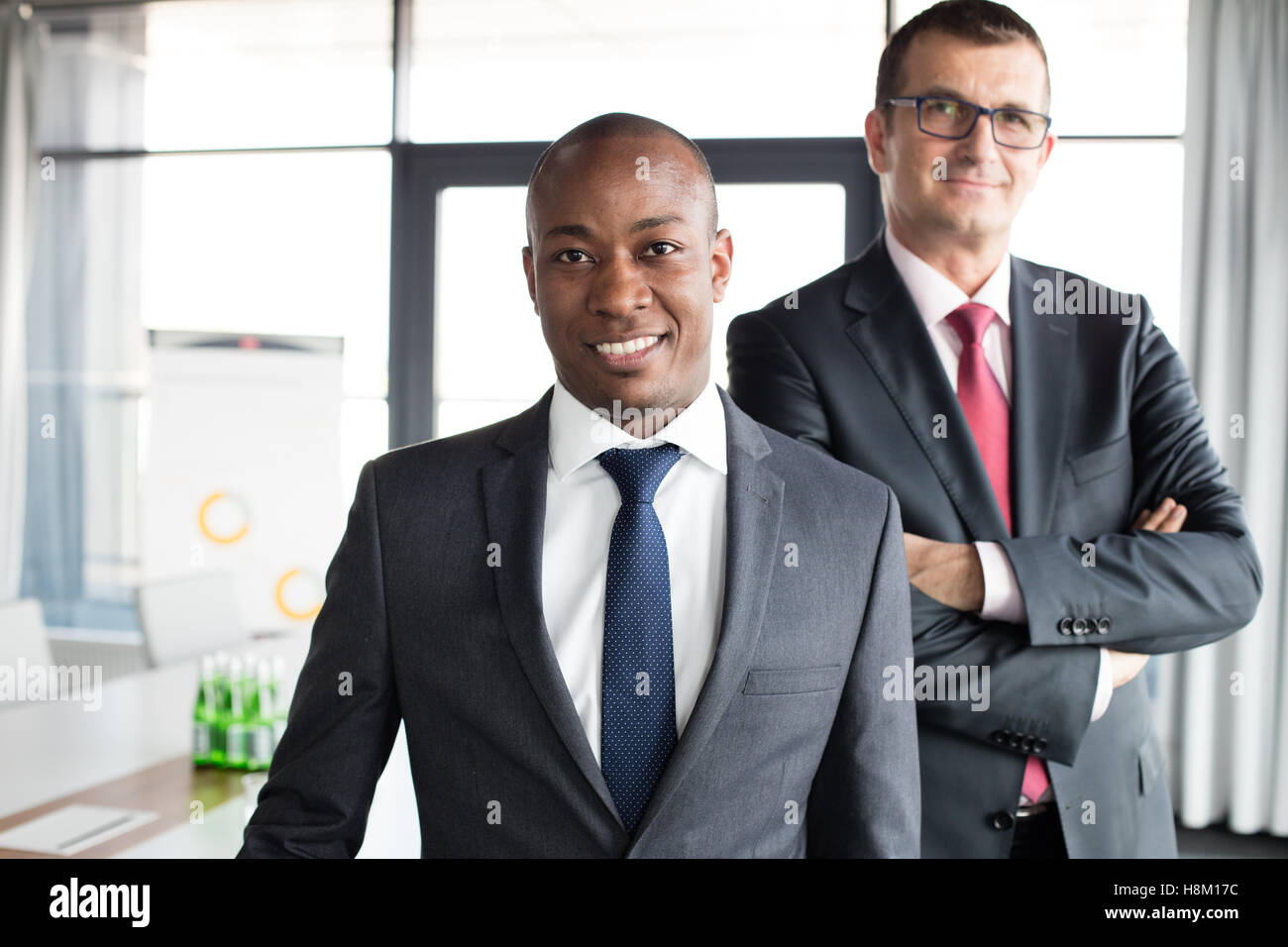 Portrait of smiling businessman with male colleague in office Banque D'Images