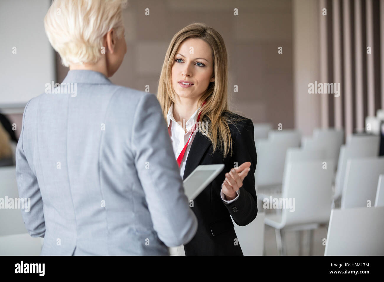 Businesswoman discussion avec tes collègues de sexe féminin en salle de séminaire Banque D'Images