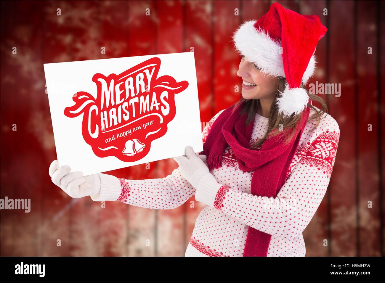 Beautiful woman in santa hat holding christmas placard Banque D'Images