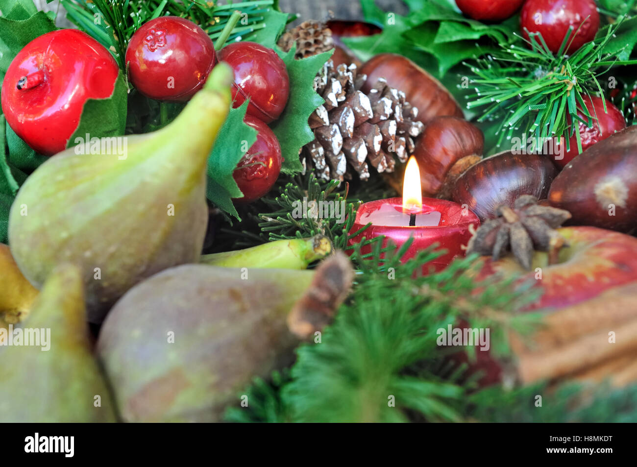 Figues et châtaignes en décoration de Noël avec une bougie Banque D'Images