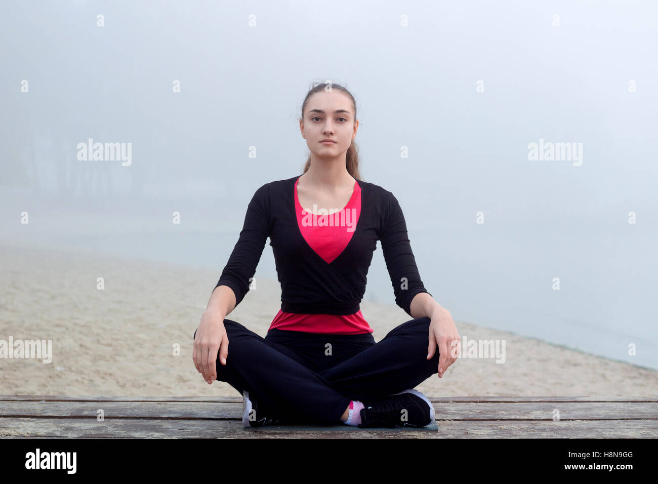 Jolie jeune femme sportive remise en forme slim n'exerce pendant la formation de yoga en plein air d'entraînement Banque D'Images