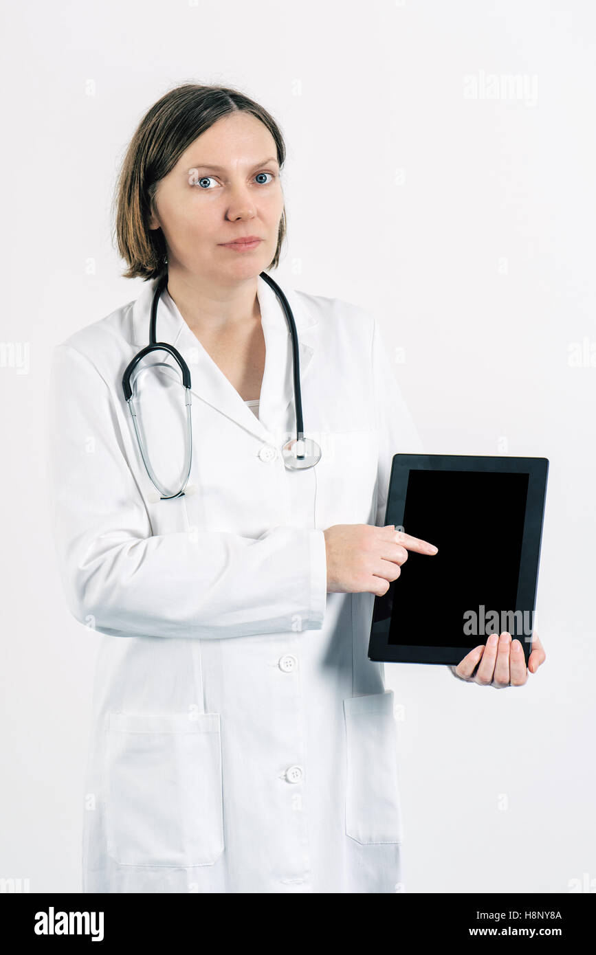 Femme médecin pointer du doigt à l'écran de l'ordinateur tablette vierge comme copy space Banque D'Images