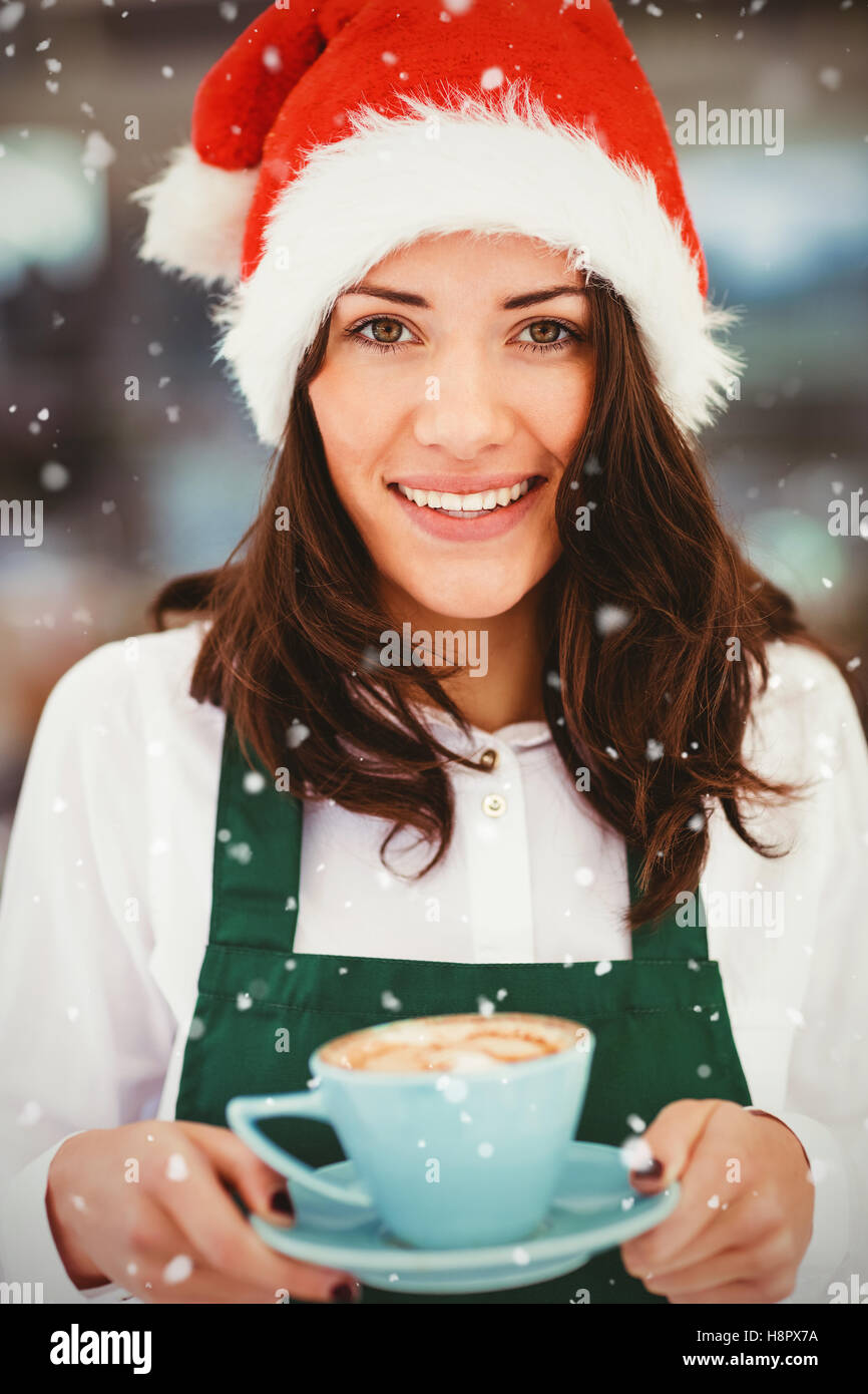 Image composite de portrait of woman with santa hat holding coffee Banque D'Images