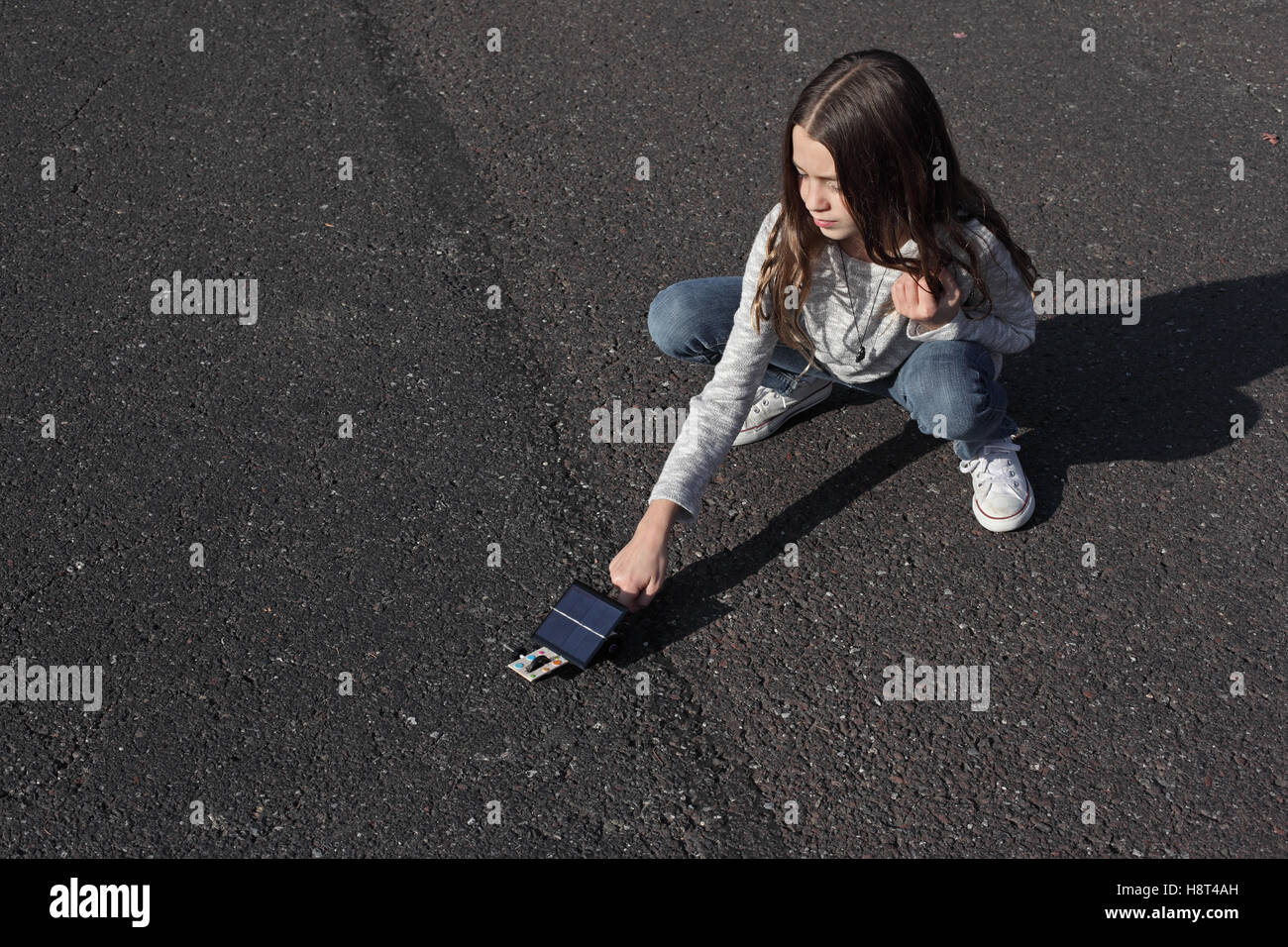 Test de fille de sa voiture solaire pour projet d'école. Banque D'Images