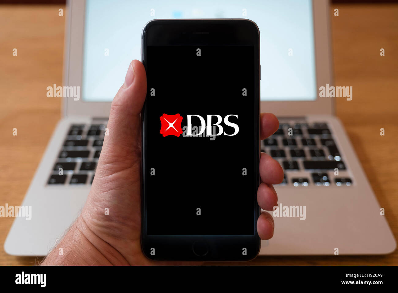 L'utilisation de l'iPhone téléphone intelligent pour afficher le logo du site web de DBS, une multinationale singapourienne groupe bancaire et financier Banque D'Images