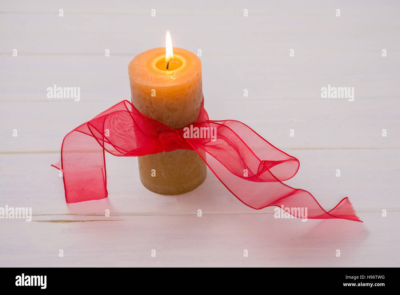 Les bougies et les rubans sur une table en bois blanc Banque D'Images