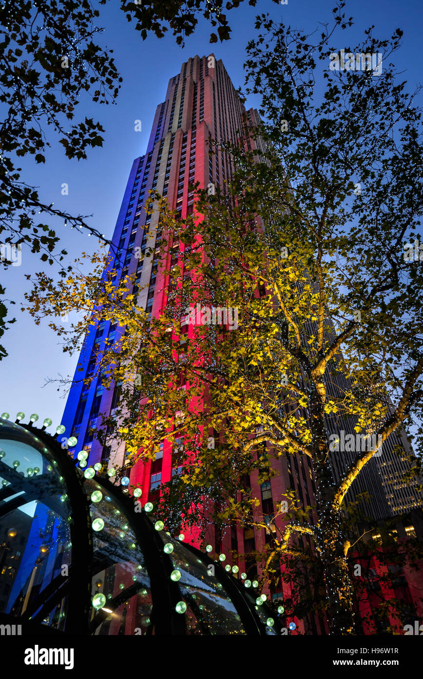 Le Centre Rockefeller illuminée en rouge, blanc et bleu au crépuscule. Manhattan, New York City Banque D'Images