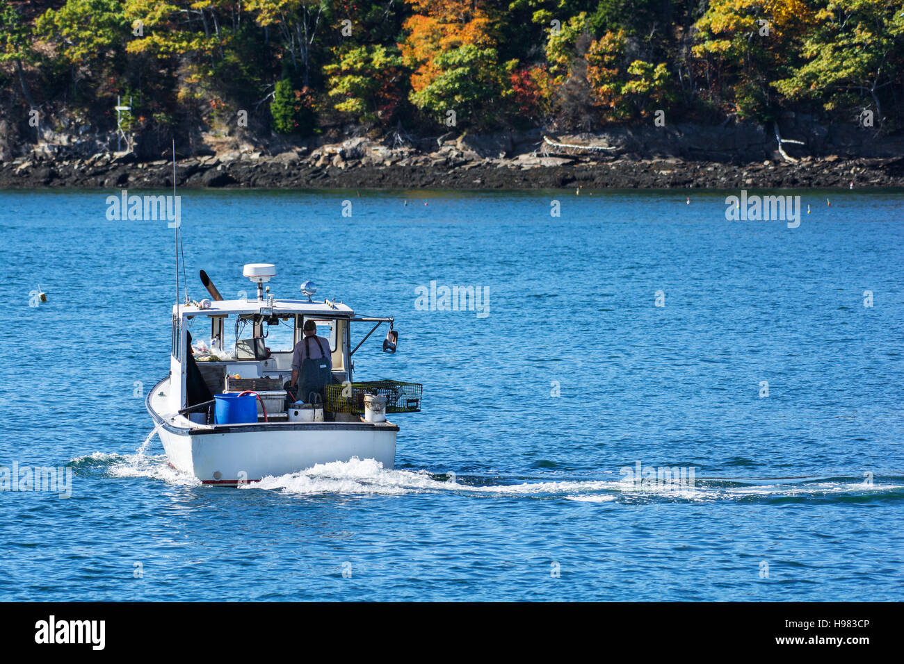 Bateau de pêche au homard à l'automne contre l'eau de l'océan bleu profond sur la côte du Maine, New England Banque D'Images