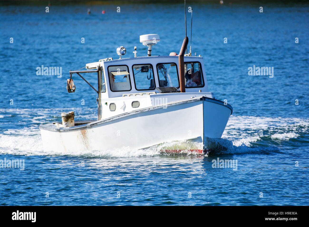 Bateau de pêche au homard à l'automne contre l'eau de l'océan bleu profond sur la côte du Maine, New England Banque D'Images