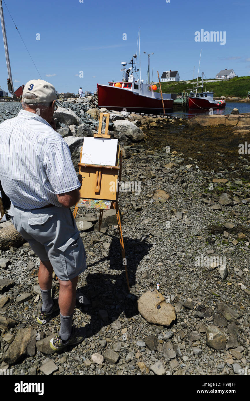 Un homme peint des bateaux de pêche et paysages au bord de l'eau dans le village de pêcheurs de Peggy's Cove, en Nouvelle-Écosse, Canada. Banque D'Images