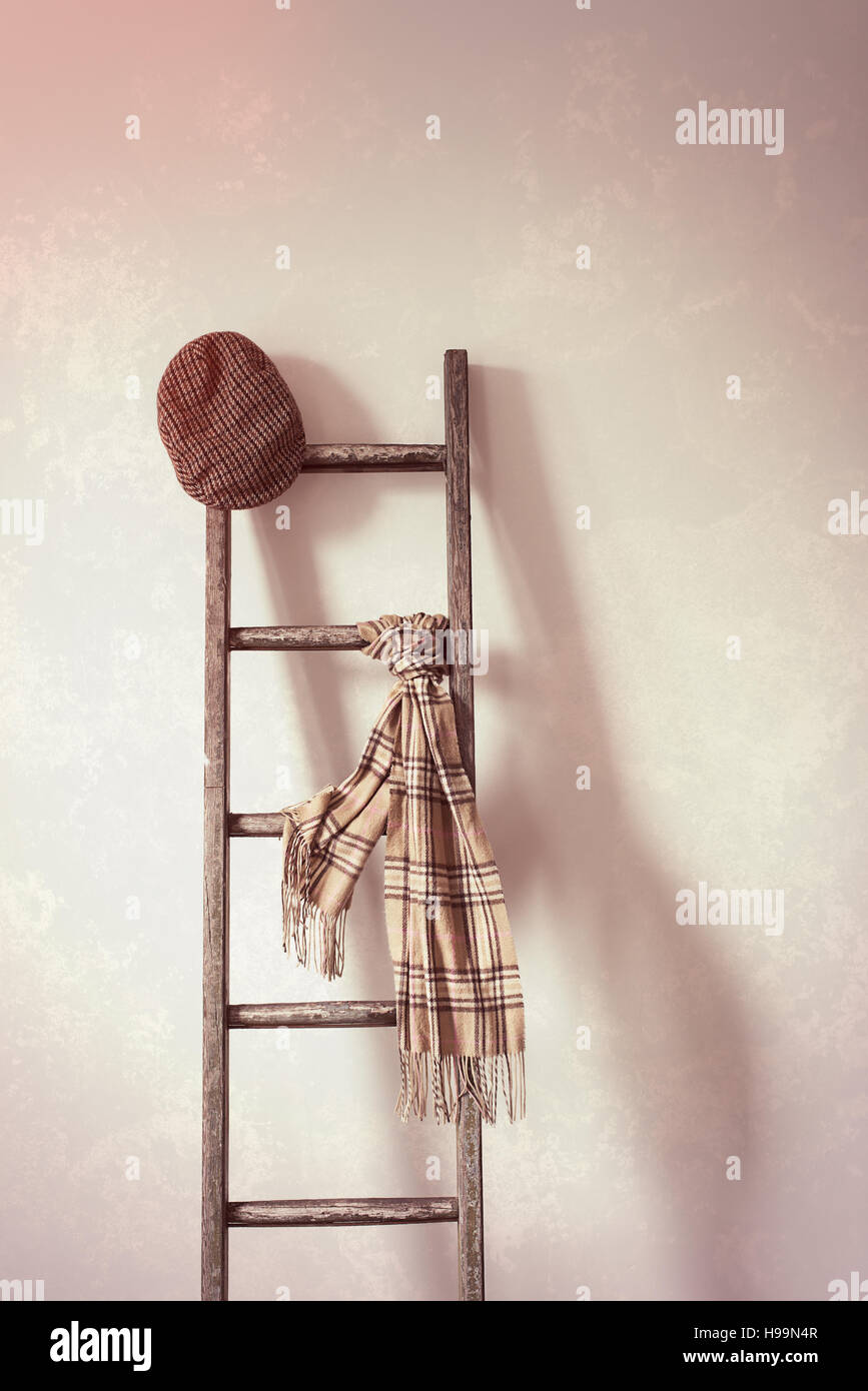 Télévision cap et écharpe sur échelle en bois rustique Banque D'Images